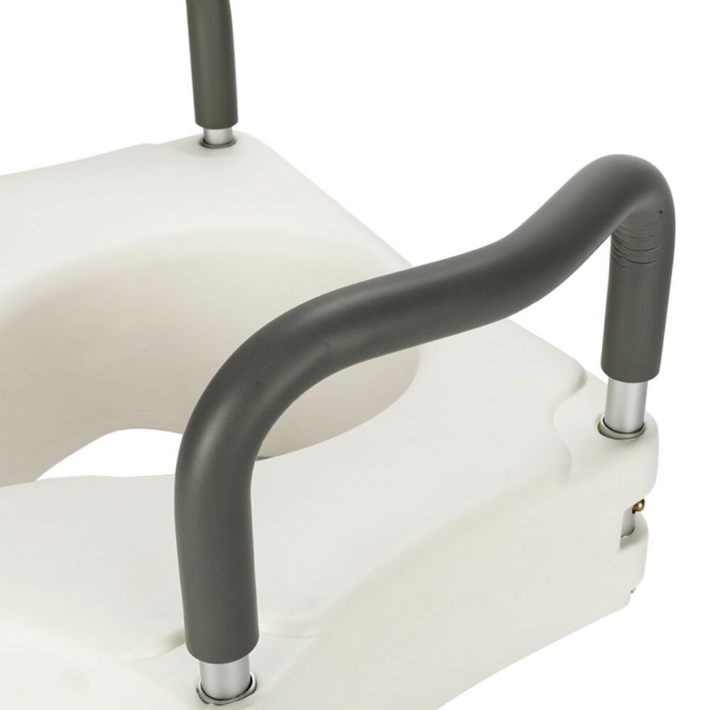A raised toilet seat with moulded armrests fitted to a standard bowl